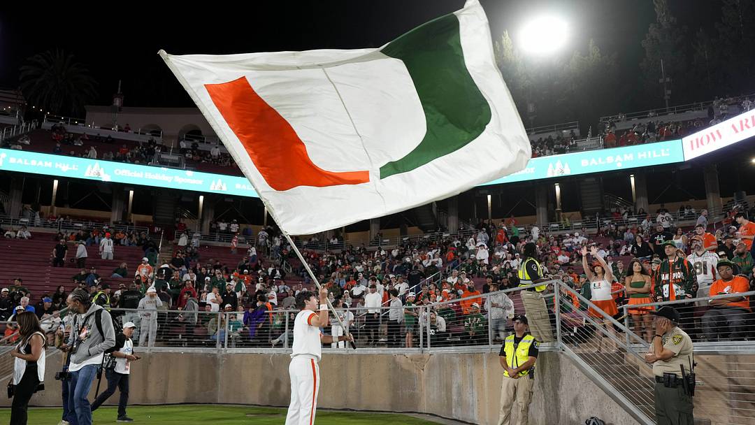 Sep 4, 2026; Stanford, California, USA;  A Miami Hurricanes cheerleader waves a flag during the fourth quarter against the Stanford Cardinal at Stanford Stadium.  Mandatory Credit: Stan Szeto-Imagn Images