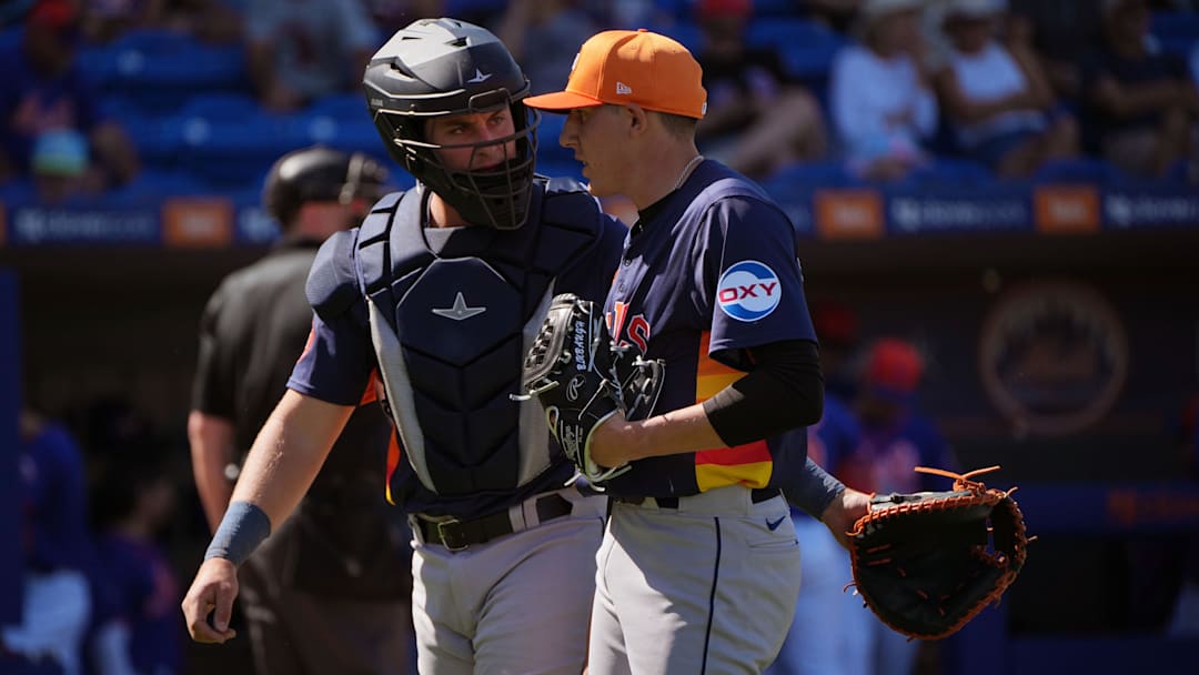 Former Houston Astros catcher CJ Stubbs (80) and pitcher AJ Blubaugh (69) meet as they walk back to the dugout during the game against the New York Mets at Clover Park.