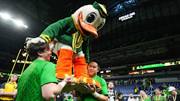The Oregon Duck is lifted up by cheerleaders on Sunday, Dec. 8, 2024, after the Big Ten Championship game at Lucas Oil Stadium in Indianapolis. The Oregon Ducks defeated the Penn State Nittany Lions, 45-37.