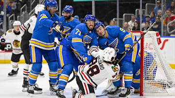 Mar 22, 2025; St. Louis, Missouri, USA;  St. Louis Blues right wing Mathieu Joseph (71) and center Alexandre Texier (9) defend against Chicago Blackhawks center Connor Bedard (98) during the third period at Enterprise Center. Mandatory Credit: Jeff Curry-Imagn Images
