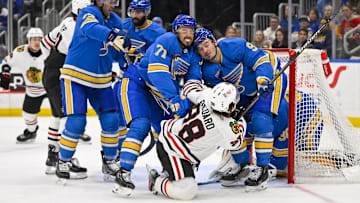 Mar 22, 2025; St. Louis, Missouri, USA;  St. Louis Blues right wing Mathieu Joseph (71) and center Alexandre Texier (9) defend against Chicago Blackhawks center Connor Bedard (98) during the third period at Enterprise Center. Mandatory Credit: Jeff Curry-Imagn Images