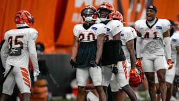 The defense celebrates after Cincinnati Bengals cornerback DJ Turner II (20) breaks up a pass to wide receiver Tee Higgins (5) during a preseason training camp practice in downtown Cincinnati on Thursday, July 31, 2025.