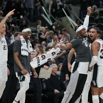 Mar 22, 2024; San Antonio, Texas, USA; San Antonio Spurs guard Blake Wesley (14) celebrates with guard Tre Jones (33) after Jones’ game-tying three-point shot in the second half against the Memphis Grizzlies at Frost Bank Center. Mandatory Credit: Daniel Dunn-Imagn Images