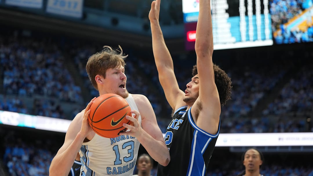 Feb 7, 2026; Chapel Hill, North Carolina, USA; North Carolina Tar Heels center Henri Veesaar (13) with the ball as Duke Blue Devils forward Cameron Boozer (12) defends in the second  half at Dean E. Smith Center. Mandatory Credit: Bob Donnan-Imagn Images