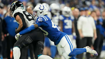 Indianapolis Colts cornerback Jaylon Jones (40) works to bring down Jacksonville Jaguars tight end Brenton Strange (85) on Sunday, Jan. 5, 2025, during a game against the Jacksonville Jaguars at Lucas Oil Stadium in Indianapolis.