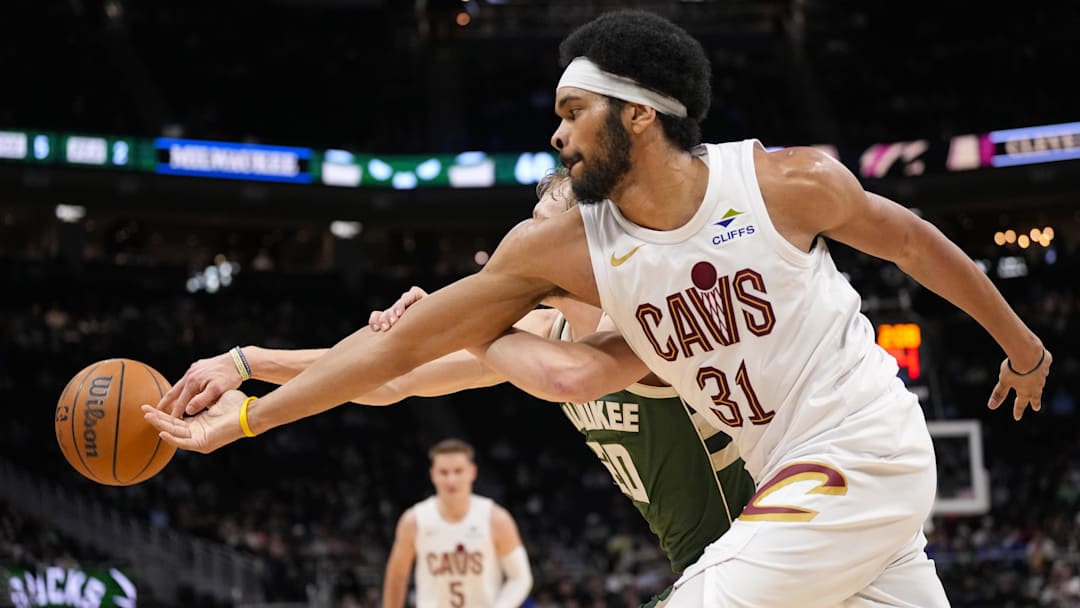Feb 25, 2026; Milwaukee, Wisconsin, USA;  Cleveland Cavaliers center Jarrett Allen (31) and Milwaukee Bucks guard AJ Green (20) reach for the loose ball during the second quarter at Fiserv Forum. Mandatory Credit: Jeff Hanisch-Imagn Images