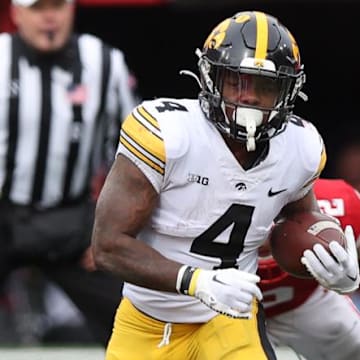 Nov 24, 2023; Lincoln, Nebraska, USA; Iowa Hawkeyes running back Leshon Williams (4) runs the football against the Nebraska Cornhuskers at Memorial Stadium. Mandatory Credit: Reese Strickland-Imagn Images
