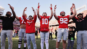 Nov 22, 2025; Columbus, Ohio, USA; Ohio State Buckeyes quarterback Julian Sayin (10), defensive end Caden Curry (92) and offensive lineman Carson Hinzman (75) (obscured) acknowledge the crowd after defeating the Rutgers Scarlet Knights at Ohio Stadium. Mandatory Credit: Joseph Maiorana-Imagn Images
