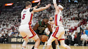 Apr 27, 2024; Miami, Florida, USA; Boston Celtics guard Jaylen Brown (7) looks for space as Miami Heat forward Nikola Jovic (5) and guard Tyler Herro (14) defend in the first half during game three of the first round for the 2024 NBA playoffs at Kaseya Center. Mandatory Credit: Jim Rassol-Imagn Images