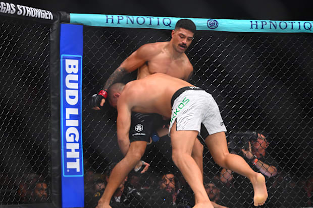 Junior Tafa (red gloves) fights Tuco Tokkos (blue gloves) in the light heavyweight bout  during UFC Fight Night.