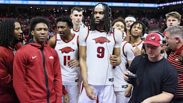 Mar 8, 2025; Fayetteville, Arkansas, USA; Arkansas Razorbacks forward Jonas Aidoo (9), flanked by teammates  is interviewed after the game against the Mississippi State Bulldogs at Bud Walton Arena. Arkansas won 93-92. Mandatory Credit: Nelson Chenault-Imagn Images