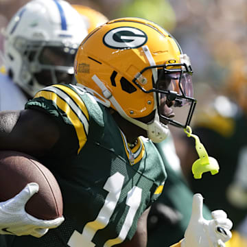 Sep 15, 2024; Green Bay, Wisconsin, USA;  Green Bay Packers wide receiver Jayden Reed (11) rushes with the football after catching a pass during the first quarter against the Indianapolis Colts at Lambeau Field. Mandatory Credit: Jeff Hanisch-Imagn Images