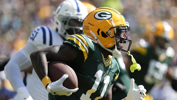 Sep 15, 2024; Green Bay, Wisconsin, USA;  Green Bay Packers wide receiver Jayden Reed (11) rushes with the football after catching a pass during the first quarter against the Indianapolis Colts at Lambeau Field. Mandatory Credit: Jeff Hanisch-Imagn Images