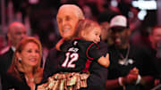 Oct 23, 2024; Miami, Florida, USA;  Miami Heat president Pat Riley holds his granddaughter following the Pat Riley Court dedication ceremony at halftime at Kaseya Center. Mandatory Credit: Jim Rassol-Imagn Images