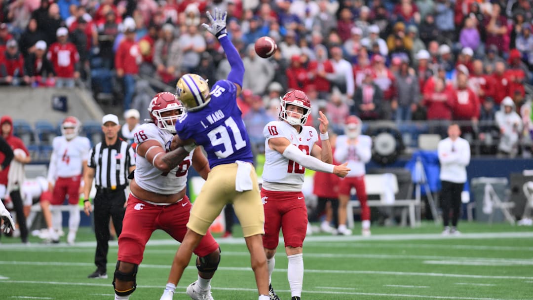 Sep 14, 2024; Seattle, Washington, USA; Washington State Cougars quarterback John Mateer (10) passes the ball over Washington Huskies edge Isaiah Ward (91) during the second half at Lumen Field. Mandatory Credit: Steven Bisig-Imagn Images