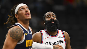 Oct 12, 2025; Inglewood, California, USA; Los Angeles Clippers guard James Harden (1) looks to rebound against Denver Nuggets forward Aaron Gordon (32) during the second quarter at Intuit Dome. Mandatory Credit: Jonathan Hui-Imagn Images