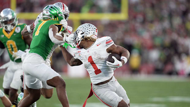 Ohio State Buckeyes running back Quinshon Judkins (1) runs against Oregon Ducks defensive back Jabbar Muhammad (7) in the thi