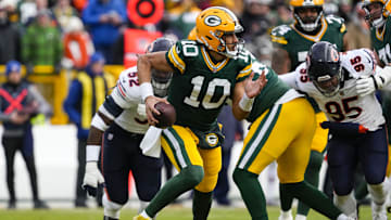 Jan 5, 2025; Green Bay, Wisconsin, USA;  Green Bay Packers quarterback Jordan Love (10) scrambles to avoid pressure during the first quarter against the Chicago Bears at Lambeau Field. Mandatory Credit: Jeff Hanisch-Imagn Images