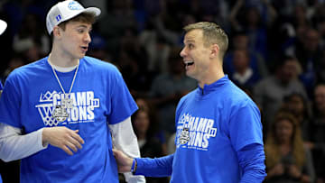 Mar 15, 2025; Charlotte, NC, USA; Duke Blue Devils forward Cooper Flagg (2) and head coach Jon Scheyer celebrate after winning the 2025 ACC Conference Championship game against the Louisville Cardinals at Spectrum Center. Mandatory Credit: Bob Donnan-Imagn Images