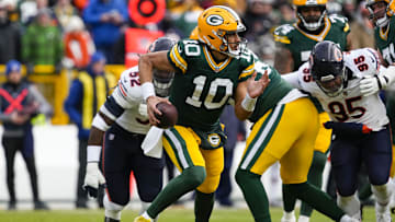 Jan 5, 2025; Green Bay, Wisconsin, USA;  Green Bay Packers quarterback Jordan Love (10) scrambles to avoid pressure during the first quarter against the Chicago Bears at Lambeau Field. Mandatory Credit: Jeff Hanisch-Imagn Images