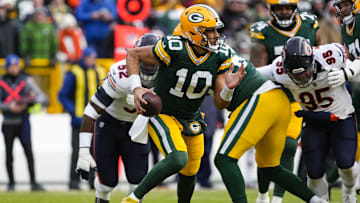 Jan 5, 2025; Green Bay, Wisconsin, USA;  Green Bay Packers quarterback Jordan Love (10) scrambles to avoid pressure during the first quarter against the Chicago Bears at Lambeau Field. Mandatory Credit: Jeff Hanisch-Imagn Images