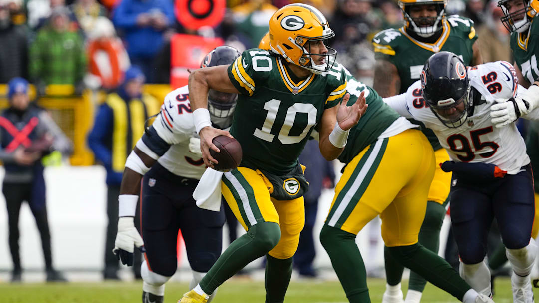Jan 5, 2025; Green Bay, Wisconsin, USA;  Green Bay Packers quarterback Jordan Love (10) scrambles to avoid pressure during the first quarter against the Chicago Bears at Lambeau Field. Mandatory Credit: Jeff Hanisch-Imagn Images