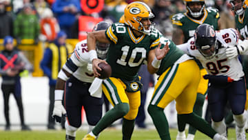 Jan 5, 2025; Green Bay, Wisconsin, USA;  Green Bay Packers quarterback Jordan Love (10) scrambles to avoid pressure during the first quarter against the Chicago Bears at Lambeau Field. Mandatory Credit: Jeff Hanisch-Imagn Images