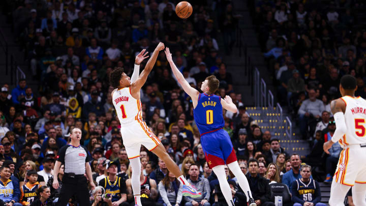 Apr 6, 2024; Denver, Colorado, USA; Atlanta Hawks forward Jalen Johnson (1) takes a shot over Denver Nuggets guard Christian Braun (0) in the first half at Ball Arena. Mandatory Credit: Michael Ciaglo-USA TODAY Sports