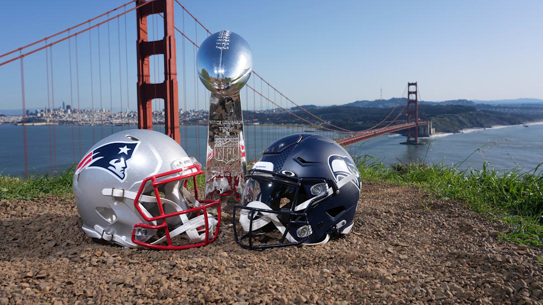 New England Patriots and Seattle Seahawks helmets with a Vince Lombardi Super Bowl trophy.