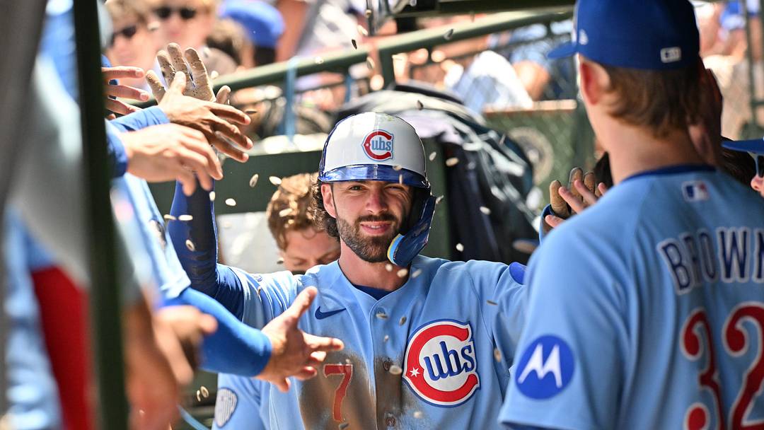 Jun 19, 2026; Chicago, Illinois, USA; Chicago Cubs shortstop Dansby Swanson (7) celebrates with teammates in the dugout after scoring against the Toronto Blue Jays during the first inning at Wrigley Field. Mandatory Credit: Patrick Gorski-Imagn Images