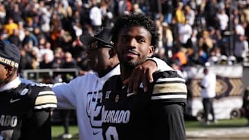 Nov 29, 2024; Boulder, Colorado, USA; Colorado Buffaloes quarterback Shedeur Sanders (2) and head coach Deion Sanders following the win over the Oklahoma State Cowboys at Folsom Field.