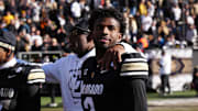 Nov 29, 2024; Boulder, Colorado, USA; Colorado Buffaloes quarterback Shedeur Sanders (2) and head coach Deion Sanders ifollowing the win over the Oklahoma State Cowboys at Folsom Field. Mandatory Credit: Ron Chenoy-Imagn Images