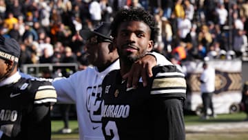 Nov 29, 2024; Boulder, Colorado, USA; Colorado Buffaloes quarterback Shedeur Sanders (2) and head coach Deion Sanders ifollowing the win over the Oklahoma State Cowboys at Folsom Field. Mandatory Credit: Ron Chenoy-Imagn Images
