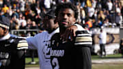 Colorado Buffaloes quarterback Shedeur Sanders and head coach Deion Sanders.