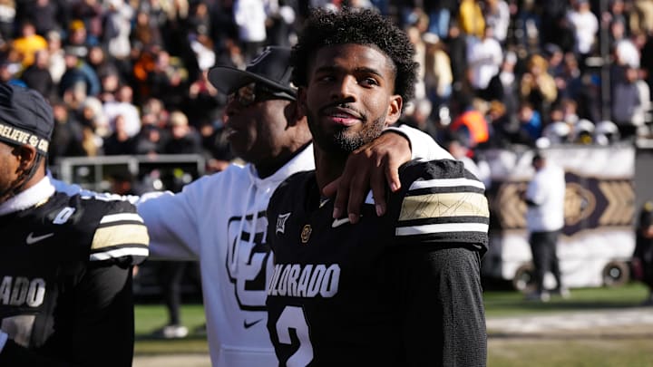 Quarterback Shedeur Sanders (2) and head coach Deion Sanders following the win over the Oklahoma State Cowboys at Folsom Field. 