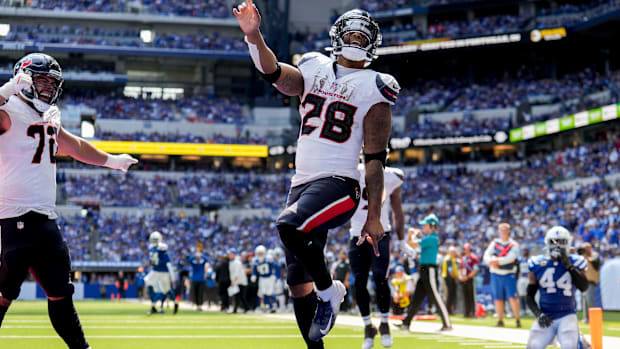 Texans running back Joe Mixon (white jersey; blue pants/helmet) celebrates after scoring a touchdown. 