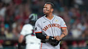 San Francisco Giants designated hitter Rafael Devers (16) sheds his gear after striking out against the Arizona Diamondbacks during the first inning at Chase Field.