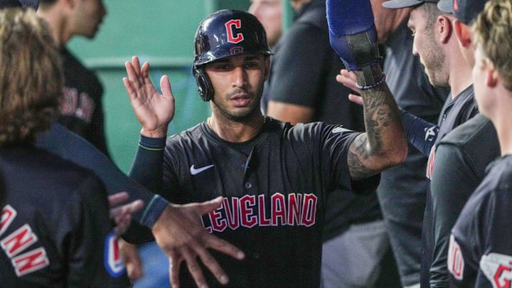 Sep 3, 2024; Kansas City, Missouri, USA; Cleveland Guardians shortstop Brayan Rocchio (4) celebrates in the dugout against the Kansas City Royals after scoring in the fifth inning at Kauffman Stadium. Mandatory Credit: Denny Medley-Imagn Images