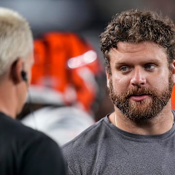 Cincinnati Bengals center Ted Karras (64) talks with Joe Burrow on the sideline in the fourth quarter of the NFL Preseason Week 1 game between the Cincinnati Bengals and the Tampa Bay Buccaneers at Paycor Stadium in downtown Cincinnati on Saturday, Aug. 10, 2024. The Tampa Bay Buccaneers beat the Bengals 17-14.