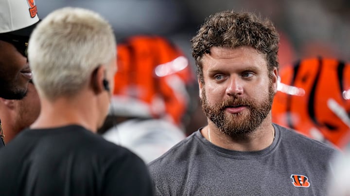 Cincinnati Bengals center Ted Karras (64) talks with Joe Burrow on the sideline in the fourth quarter of the NFL Preseason Week 1 game between the Cincinnati Bengals and the Tampa Bay Buccaneers at Paycor Stadium in downtown Cincinnati on Saturday, Aug. 10, 2024. The Tampa Bay Buccaneers beat the Bengals 17-14.