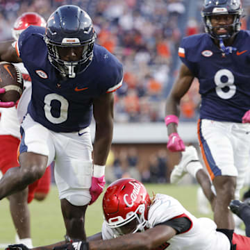 Oct 12, 2024; Charlottesville, Virginia, USA; Virginia Cavaliers running back Xavier Brown (0) carries the ball to score a touchdown against the Louisville Cardinals during the second half at Scott Stadium. Mandatory Credit: Amber Searls-Imagn Images