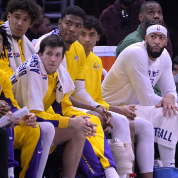 Jan 23, 2024; Los Angeles, California, USA; Los Angeles Lakers guard Jalen Hood-Schifino (0) and guard Austin Reaves (15) and forward Rui Hachimura (28) and guard Max Christie (10) forward Anthony Davis (3) and forward LeBron James (23) look on from the bench in the second half against the Los Angeles Clippers at Crypto.com Arena. Mandatory Credit: Jayne Kamin-Oncea-USA TODAY Sports