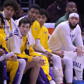 Jan 23, 2024; Los Angeles, California, USA; Los Angeles Lakers guard Jalen Hood-Schifino (0) and guard Austin Reaves (15) and forward Rui Hachimura (28) and guard Max Christie (10) forward Anthony Davis (3) and forward LeBron James (23) look on from the bench in the second half against the Los Angeles Clippers at Crypto.com Arena. Mandatory Credit: Jayne Kamin-Oncea-USA TODAY Sports
