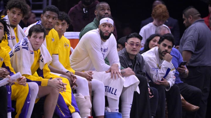 Jan 23, 2024; Los Angeles, California, USA; Los Angeles Lakers guard Jalen Hood-Schifino (0) and guard Austin Reaves (15) and forward Rui Hachimura (28) and guard Max Christie (10) forward Anthony Davis (3) and forward LeBron James (23) look on from the bench in the second half against the Los Angeles Clippers at Crypto.com Arena. Mandatory Credit: Jayne Kamin-Oncea-USA TODAY Sports