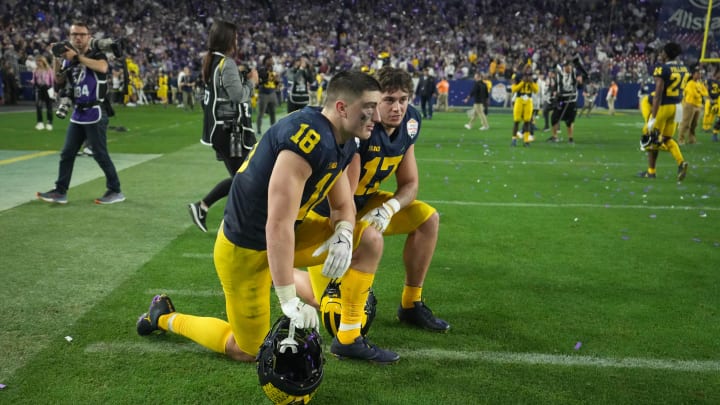 Dec 31, 2022; Glendale, Arizona, USA; Michigan Wolverines tight ends Colston Loveland (18) and Marlin Klein (17) kneel on the field after after losing to the TCU Horned Frogs in the 2022 Fiesta Bowl at State Farm Stadium. Mandatory Credit: Kirby Lee-USA TODAY Sports