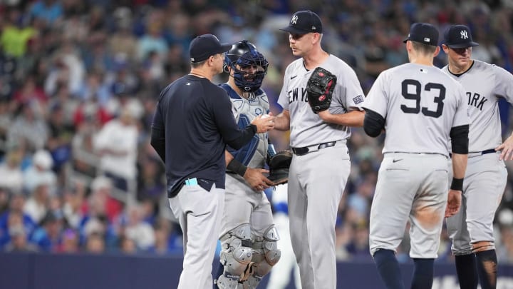 Jun 30, 2024; Toronto, Ontario, CAN; New York Yankees relief pitcher Michael Tonkin (50) is relieved by manager Aaron Boone (17) against the Toronto Blue Jays during the seventh inning at Rogers Centre. Mandatory Credit: Nick Turchiaro-USA TODAY Sports