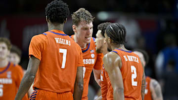 Feb 22, 2025; Dallas, Texas, USA; Clemson Tigers center Viktor Lakhin (0) and forward Chauncey Wiggins (7) and guard Chase Hunter (1) and guard Dillon Hunter (2) celebrate during the second half against the SMU Mustangs at Moody Coliseum. Mandatory Credit: Jerome Miron-Imagn Images