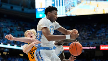 Jan 15, 2025; Chapel Hill, North Carolina, USA; North Carolina Tar Heels forward Jalen Washington (13) fight for a rebound with California Golden Bears forward Rytis Petraitis (31) in the first half at Dean E. Smith Center. Mandatory Credit: Bob Donnan-Imagn Images