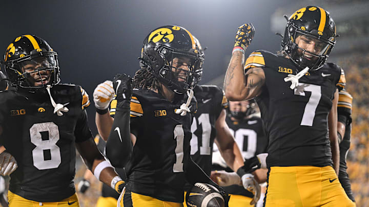 Sep 13, 2025; Iowa City, Iowa, USA; Iowa Hawkeyes wide receiver KJ Parker (1) reacts with running back Terrell Washington Jr. (8) and wide receiver Dayton Howard (7) after a touchdown reception against the Massachusetts Minutemen during the fourth quarter at Kinnick Stadium. Mandatory Credit: Jeffrey Becker-Imagn Images