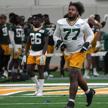 Green Bay Packers offensive tackle Jordan Morgan (77) gets warmed up during minicamp. 